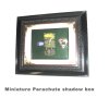 miniature parachute in shadow box