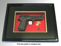 Pistol in shadow box w/glass cover
